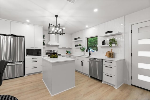 903 Cardiff Dr, Austin, TX 78745 - kitchen featuring open shelves, appliances with stainless steel finishes, custom exhaust hood, white cabinetry, and pendant lighting
