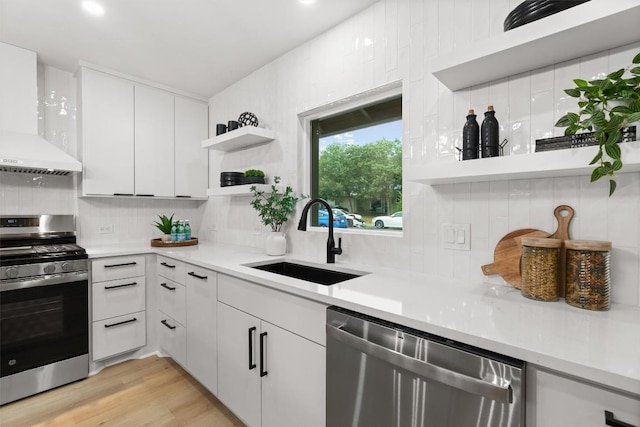 903 Cardiff Dr, Austin, TX 78745 - kitchen with appliances with stainless steel finishes, a sink, open shelves, wall chimney exhaust hood, and decorative backsplash
