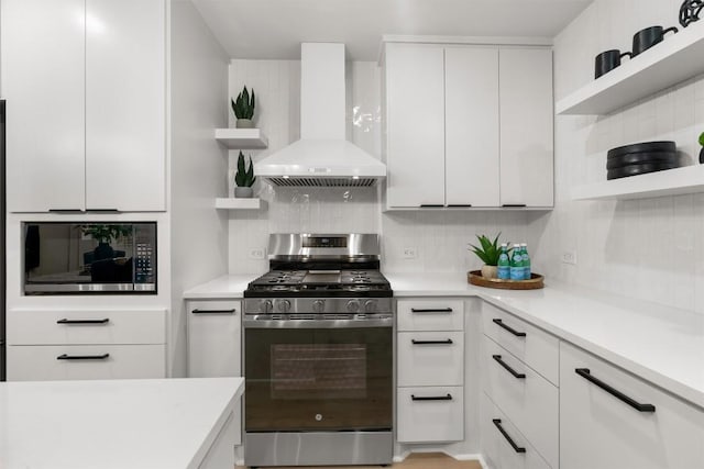 903 Cardiff Dr, Austin, TX 78745 - kitchen with open shelves, wall chimney exhaust hood, stainless steel range with gas stovetop, and black microwave
