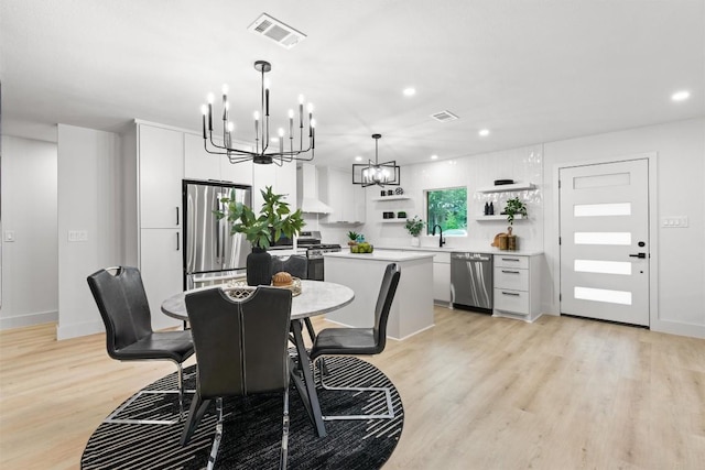 903 Cardiff Dr, Austin, TX 78745 - dining area featuring a chandelier, light wood-style flooring, recessed lighting, and baseboards