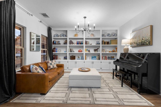 103 Bellagio Dr, Lakeway, TX 78734 - living area with a chandelier, light wood-style floors, and built in features