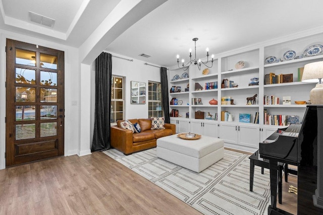 103 Bellagio Dr, Lakeway, TX 78734 - sitting room featuring a chandelier, light wood finished floors, built in features, and baseboards