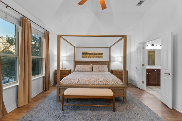 103 Bellagio Dr, Lakeway, TX 78734 - bedroom with wood finished floors, lofted ceiling, baseboards, connected bathroom, and a ceiling fan
