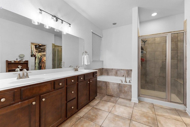 103 Bellagio Dr, Lakeway, TX 78734 - bathroom featuring a shower stall, a bath, a walk in closet, double vanity, and tile patterned floors