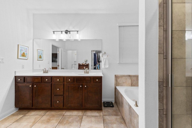 103 Bellagio Dr, Lakeway, TX 78734 - full bath featuring tile patterned floors, double vanity, a bath, and baseboards