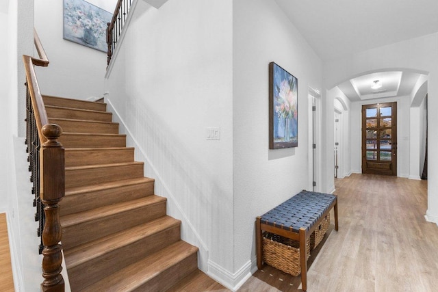 103 Bellagio Dr, Lakeway, TX 78734 - foyer entrance featuring arched walkways, wood finished floors, stairs, and baseboards