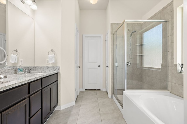 5012 Yucca Bloom Dr, Georgetown, TX 78626 - full bathroom featuring a shower stall, vanity, a garden tub, tile patterned floors, and baseboards