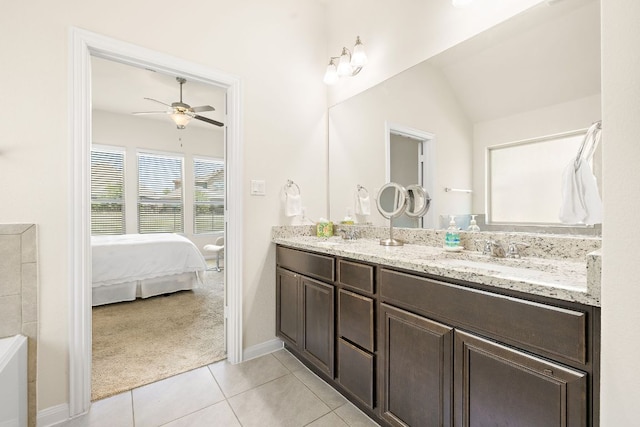 5012 Yucca Bloom Dr, Georgetown, TX 78626 - ensuite bathroom with double vanity, ceiling fan, tile patterned floors, baseboards, and lofted ceiling