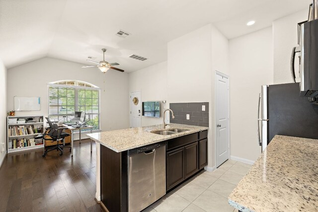 5012 Yucca Bloom Dr, Georgetown, TX 78626 - kitchen with appliances with stainless steel finishes, a sink, a ceiling fan, light stone counters, and vaulted ceiling