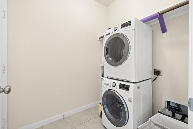 5012 Yucca Bloom Dr, Georgetown, TX 78626 - washroom featuring stacked washer and clothes dryer, light tile patterned floors, and baseboards