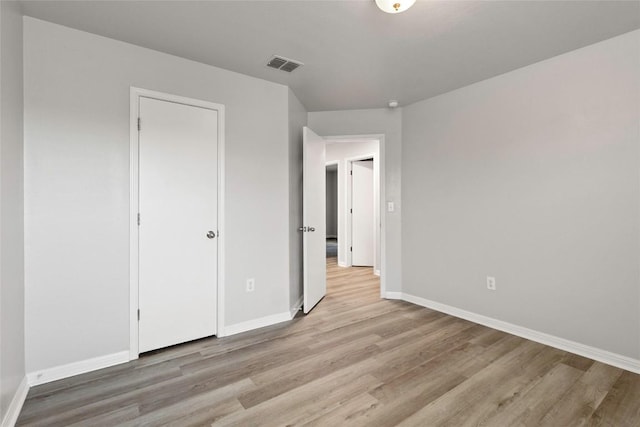 424 Wapiti Rd, Buda, TX 78610 - unfurnished bedroom with light wood-style floors and baseboards