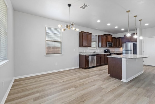 424 Wapiti Rd, Buda, TX 78610 - kitchen featuring appliances with stainless steel finishes, light wood-style flooring, dark brown cabinets, recessed lighting, and a chandelier