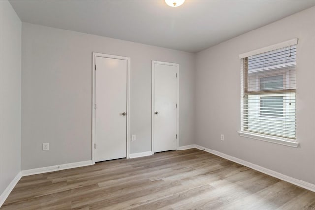 424 Wapiti Rd, Buda, TX 78610 - unfurnished bedroom featuring light wood-type flooring and baseboards