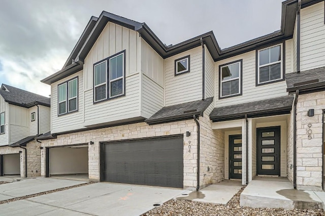 2600 Gattis School Rd Unit 1102, Round Rock, TX 78664 - townhome / multi-family property with stone siding, a garage, driveway, and board and batten siding
