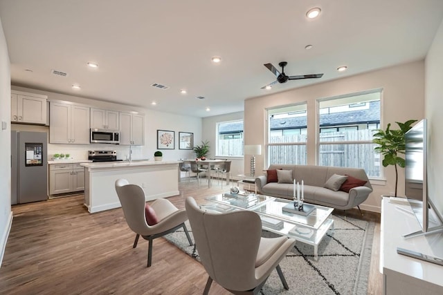 2600 Gattis School Rd Unit 1102, Round Rock, TX 78664 - living area with wood finished floors, ceiling fan, recessed lighting, and baseboards