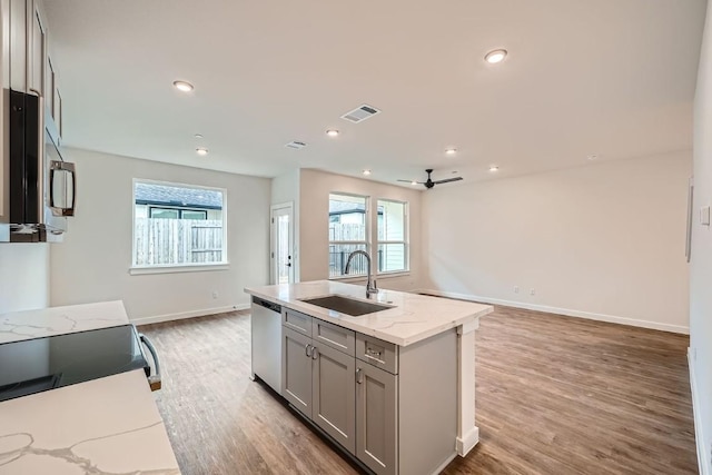 2600 Gattis School Rd Unit 1102, Round Rock, TX 78664 - kitchen featuring a sink, gray cabinetry, stainless steel appliances, open floor plan, and baseboards