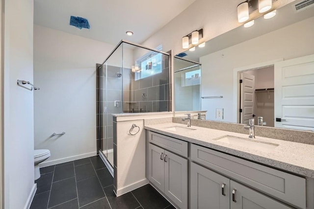 2600 Gattis School Rd Unit 1102, Round Rock, TX 78664 - full bathroom with double vanity, a stall shower, toilet, tile patterned floors, and baseboards