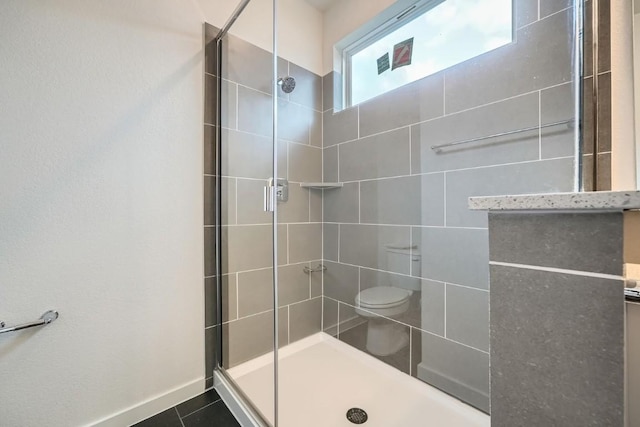 2600 Gattis School Rd Unit 1102, Round Rock, TX 78664 - bathroom with a tile shower, toilet, and baseboards