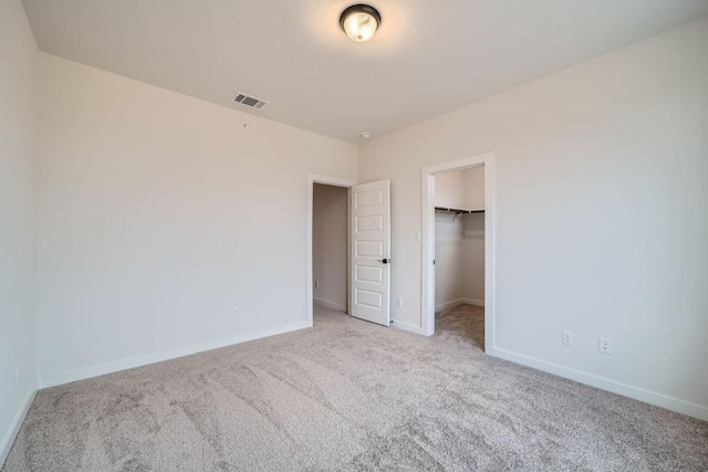 2600 Gattis School Rd Unit 1102, Round Rock, TX 78664 - unfurnished bedroom featuring carpet flooring, baseboards, a spacious closet, and a closet