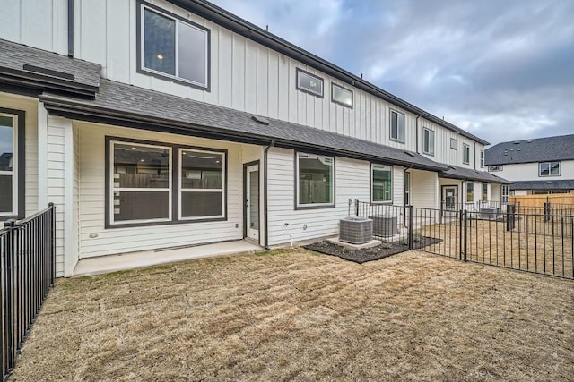 2600 Gattis School Rd Unit 1102, Round Rock, TX 78664 - rear view of house with board and batten siding, a fenced backyard, and central AC