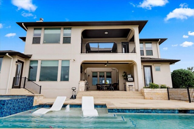2037 Portobello Rd, Leander, TX 78641 - rear view of property with a balcony, stucco siding, a patio, and an outdoor pool