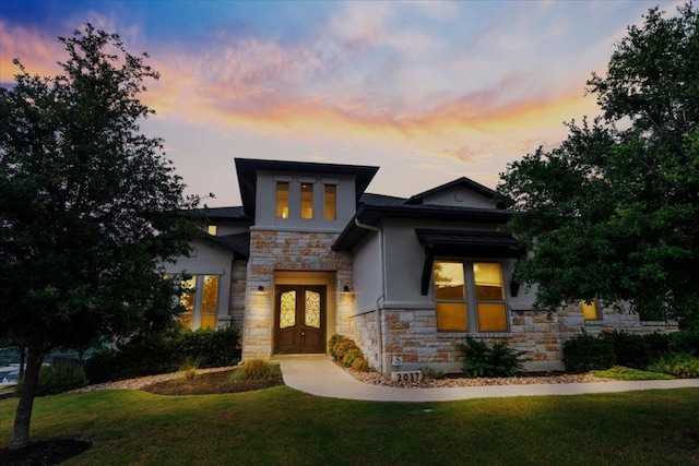 2037 Portobello Rd, Leander, TX 78641 - contemporary home featuring stone siding, stucco siding, a front lawn, and french doors