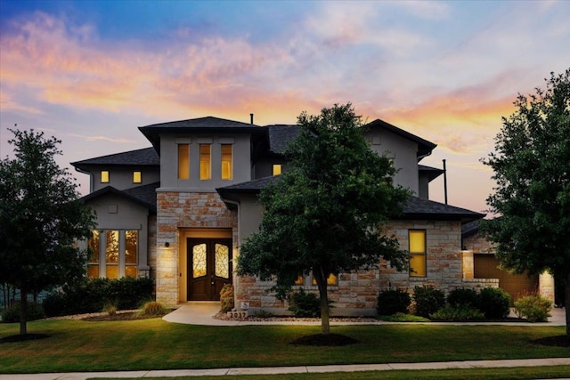 2037 Portobello Rd, Leander, TX 78641 - view of front of home with stone siding, a front lawn, french doors, and stucco siding