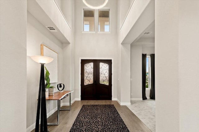 2037 Portobello Rd, Leander, TX 78641 - foyer entrance featuring wood finished floors, healthy amount of natural light, a high ceiling, and baseboards