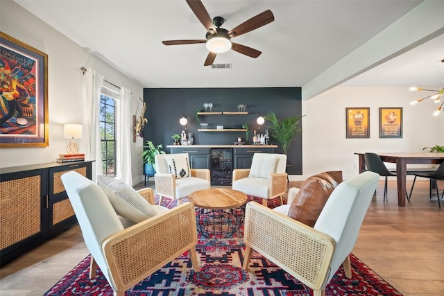 12025 Cherie Dr, Austin, TX 78758 - living room featuring a bar, wood finished floors, ceiling fan, and wine cooler