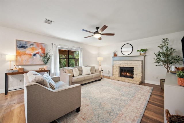 12025 Cherie Dr, Austin, TX 78758 - living room with wood finished floors, a ceiling fan, a fireplace, and baseboards