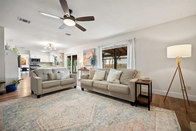 12025 Cherie Dr, Austin, TX 78758 - living room featuring baseboards, ceiling fan, and wood finished floors