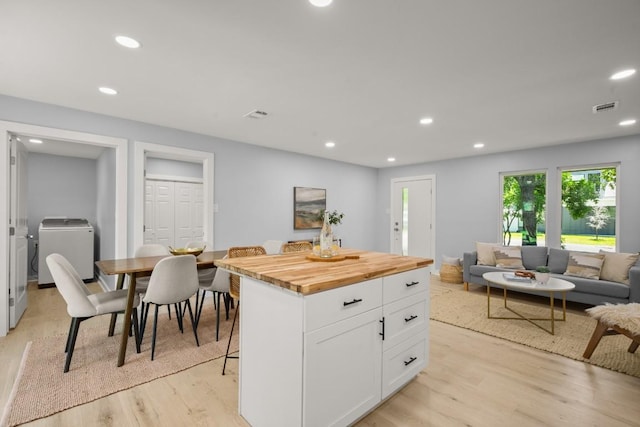 4802 Brighton Rd, Austin, TX 78745 - kitchen with white cabinetry, recessed lighting, wooden counters, light wood-style flooring, and a kitchen island