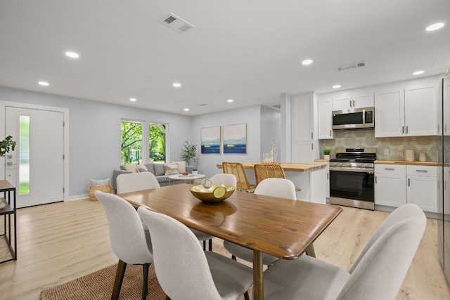 4802 Brighton Rd, Austin, TX 78745 - dining room featuring light wood-type flooring and recessed lighting