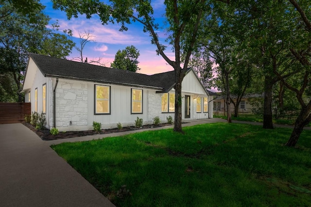 4802 Brighton Rd, Austin, TX 78745 - view of front of home featuring stone siding, roof with shingles, and board and batten siding