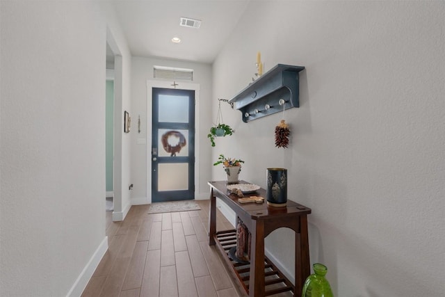 653 Coyote Creek Way, Kyle, TX 78640 - entryway with baseboards and wood finished floors