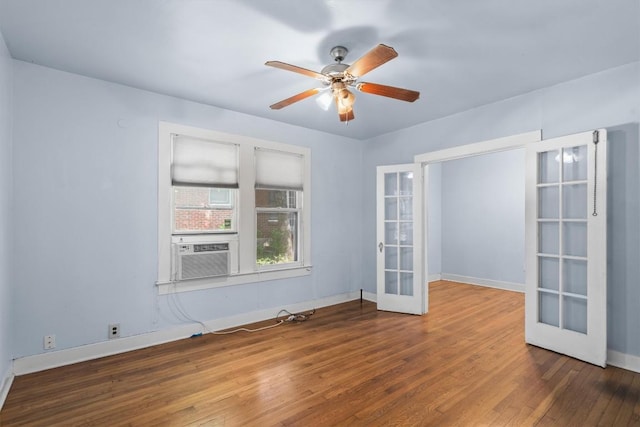 604 Harris Ave, Austin, TX 78705 - empty room featuring french doors, baseboards, wood finished floors, a ceiling fan, and cooling unit