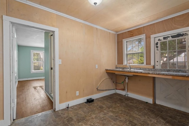604 Harris Ave, Austin, TX 78705 - washroom with dark stone finish flooring, ornamental molding, and baseboards