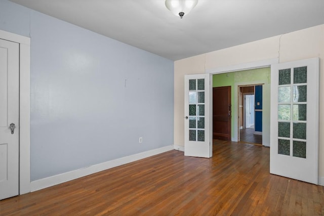 604 Harris Ave, Austin, TX 78705 - empty room with french doors, wood finished floors, and baseboards