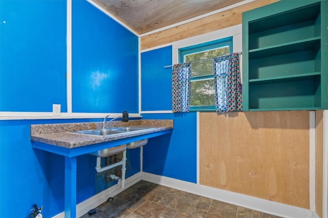 604 Harris Ave, Austin, TX 78705 - bathroom featuring a sink, baseboards, and stone finish flooring