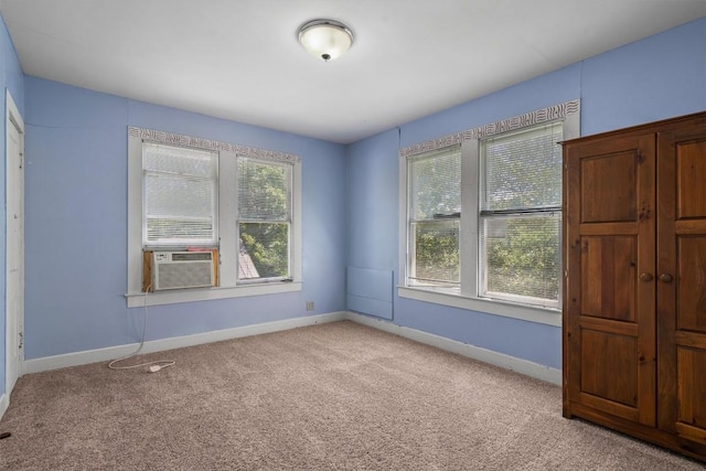 604 Harris Ave, Austin, TX 78705 - unfurnished room featuring light carpet, baseboards, and cooling unit