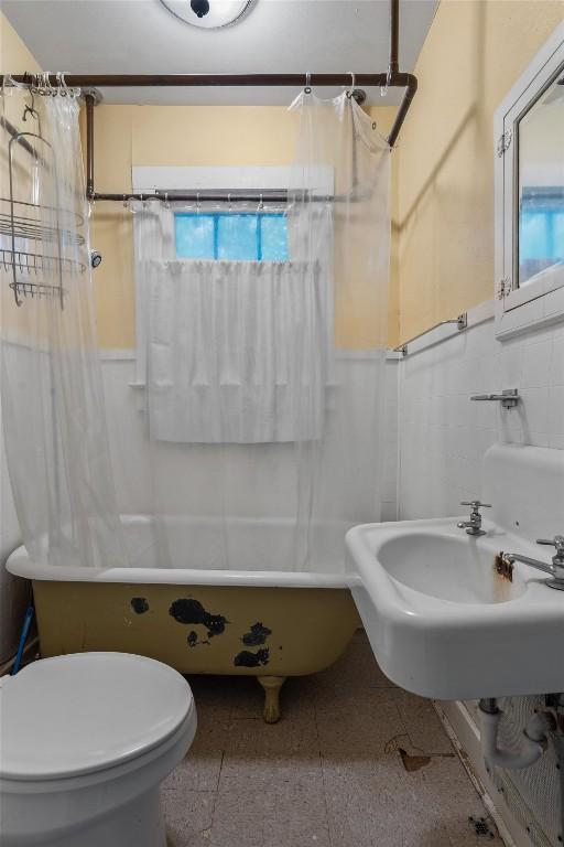604 Harris Ave, Austin, TX 78705 - bathroom with healthy amount of natural light, a wainscoted wall, and toilet
