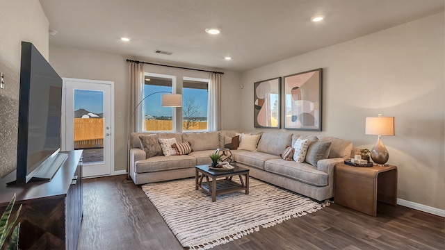 166 Caddo Bnd, Kyle, TX 78640 - living room with dark wood-style flooring, baseboards, and recessed lighting