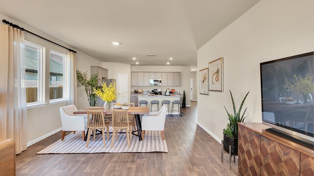166 Caddo Bnd, Kyle, TX 78640 - dining space with baseboards, wood finished floors, and recessed lighting