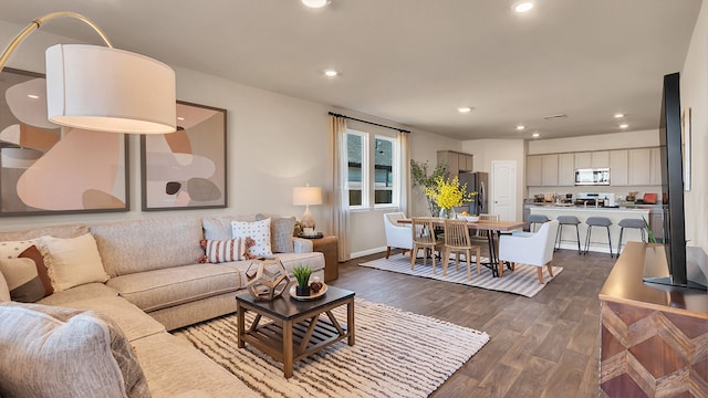 166 Caddo Bnd, Kyle, TX 78640 - living area featuring dark wood finished floors, recessed lighting, and baseboards