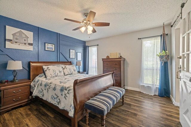 3704 Del Rio Ct, Georgetown, TX 78628 - bedroom with dark wood-style floors, a textured ceiling, multiple windows, and a ceiling fan