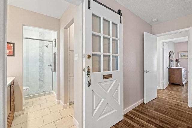 3704 Del Rio Ct, Georgetown, TX 78628 - hallway with a barn door and wood finished floors