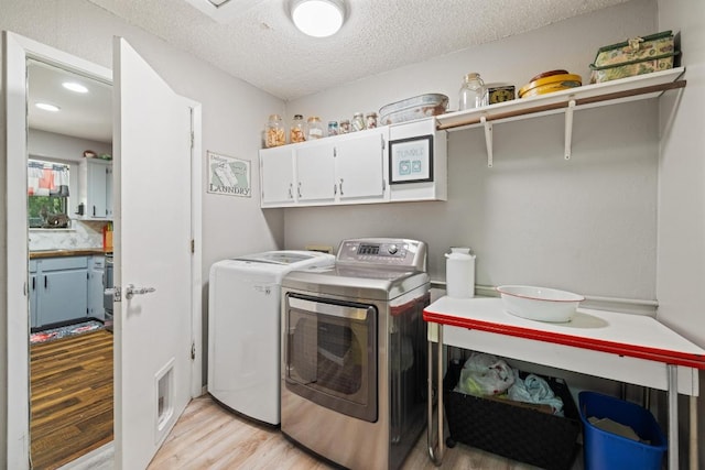 3704 Del Rio Ct, Georgetown, TX 78628 - laundry area with cabinet space, light wood-style floors, washing machine and clothes dryer, a textured ceiling, and recessed lighting