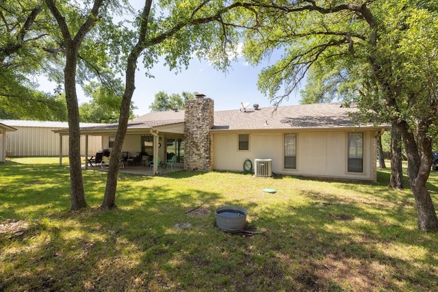 3704 Del Rio Ct, Georgetown, TX 78628 - rear view of house featuring a chimney, a patio, and a lawn