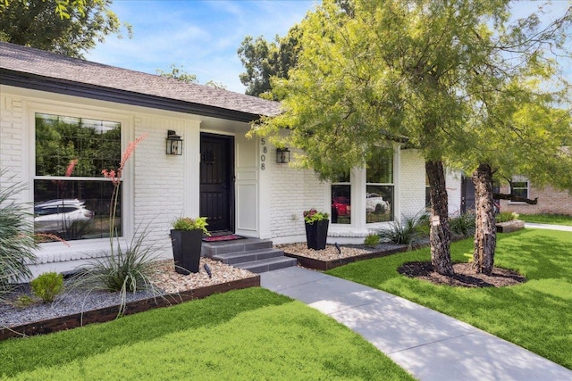 5808 Marilyn Dr, Austin, TX 78757 - view of front of house with brick siding and a front yard