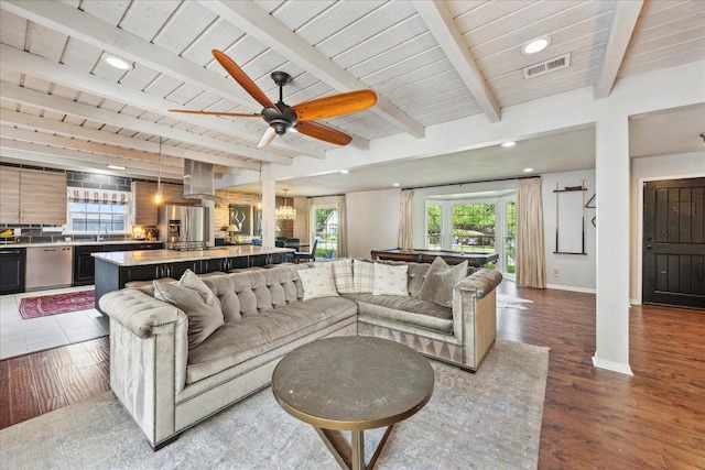 5808 Marilyn Dr, Austin, TX 78757 - living room with healthy amount of natural light, baseboards, wood ceiling with exposed beams, ceiling fan, and wood finished floors